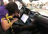 Attendees of the 2019 DEF CON cybersecurity event are seen at the conference's car hacking village in Las Vegas, Nevada, U.S., August 9, 2019