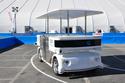 Induct's Navia autonomous shuttle drives itself around a track at CES 2014. The $250,000 electric vehicle launched this week and could be deployed at university campuses, airports, and other facilities. 