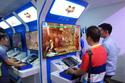 Chinese gamers play Street Fighter V at the Sony PlayStation booth at ChinaJoy.