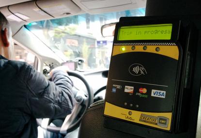 An NFC-enabled payment terminal in a San Francisco taxi that can accept both Apple Pay and Google Wallet