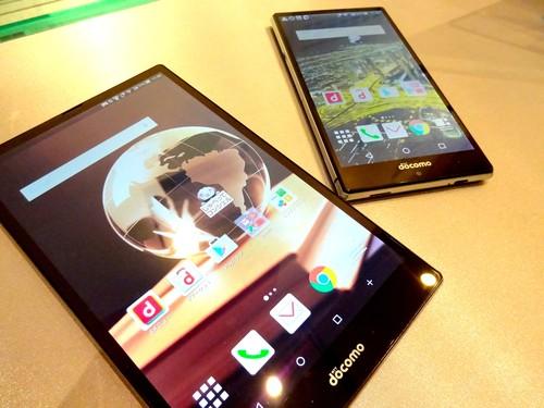 Sharp mobile devices shown off May 25, 2015, in Tokyo include a 7-inch tablet (left) weighing only 213 grams, and an Aquos smartphone that can play back slow motion video at up to 2,100 frames per second. 