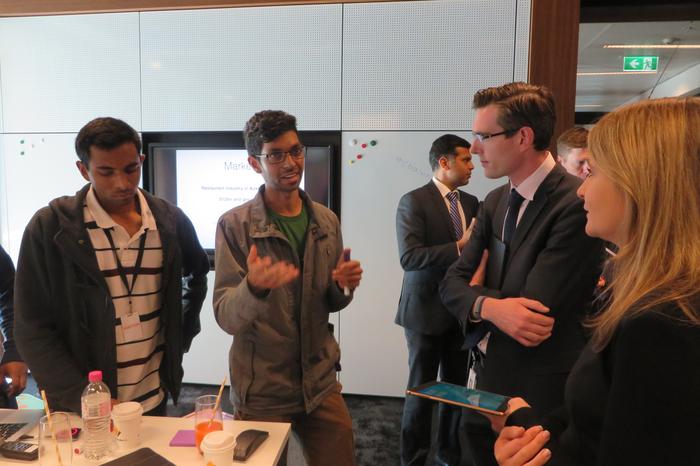 The winners of the UNSW hackathon explain their Albert app, CrowdSauce, to Dominic Perrottet, NSW minister for finance and services.