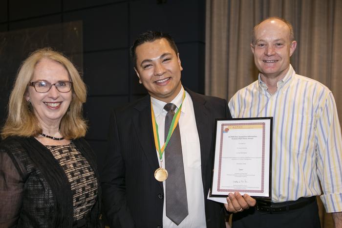 Professors Aileen Cater-Steel and Mark Toleman congratulate Dr Anup Shrestha (centre) on being awarded the annual medal by the Australian Council of Professors and Heads of Information Systems (ACPHIS) for the best PhD thesis.